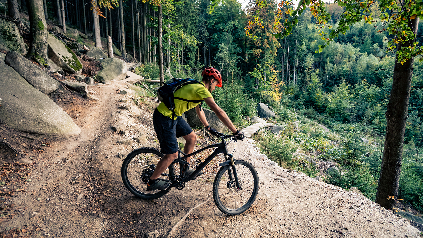Mountain biker riding on bike in autumn inspirational mountains landscape. Man cycling MTB on enduro trail track. Sport fitness motivation and inspiration.
