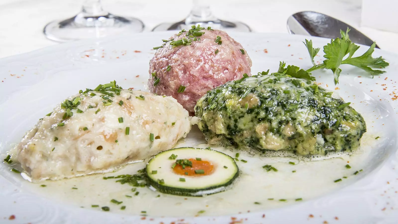 A tris of cheese -, spinach - and turnip - dumplings, served with melted butter and parsley