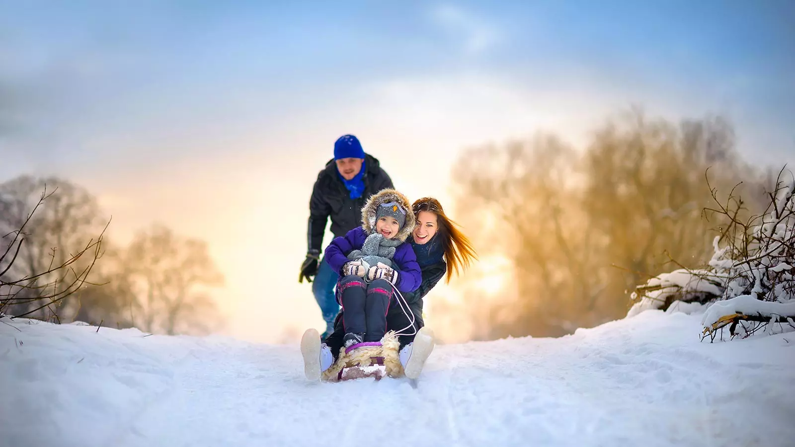 a happy family on a sledge